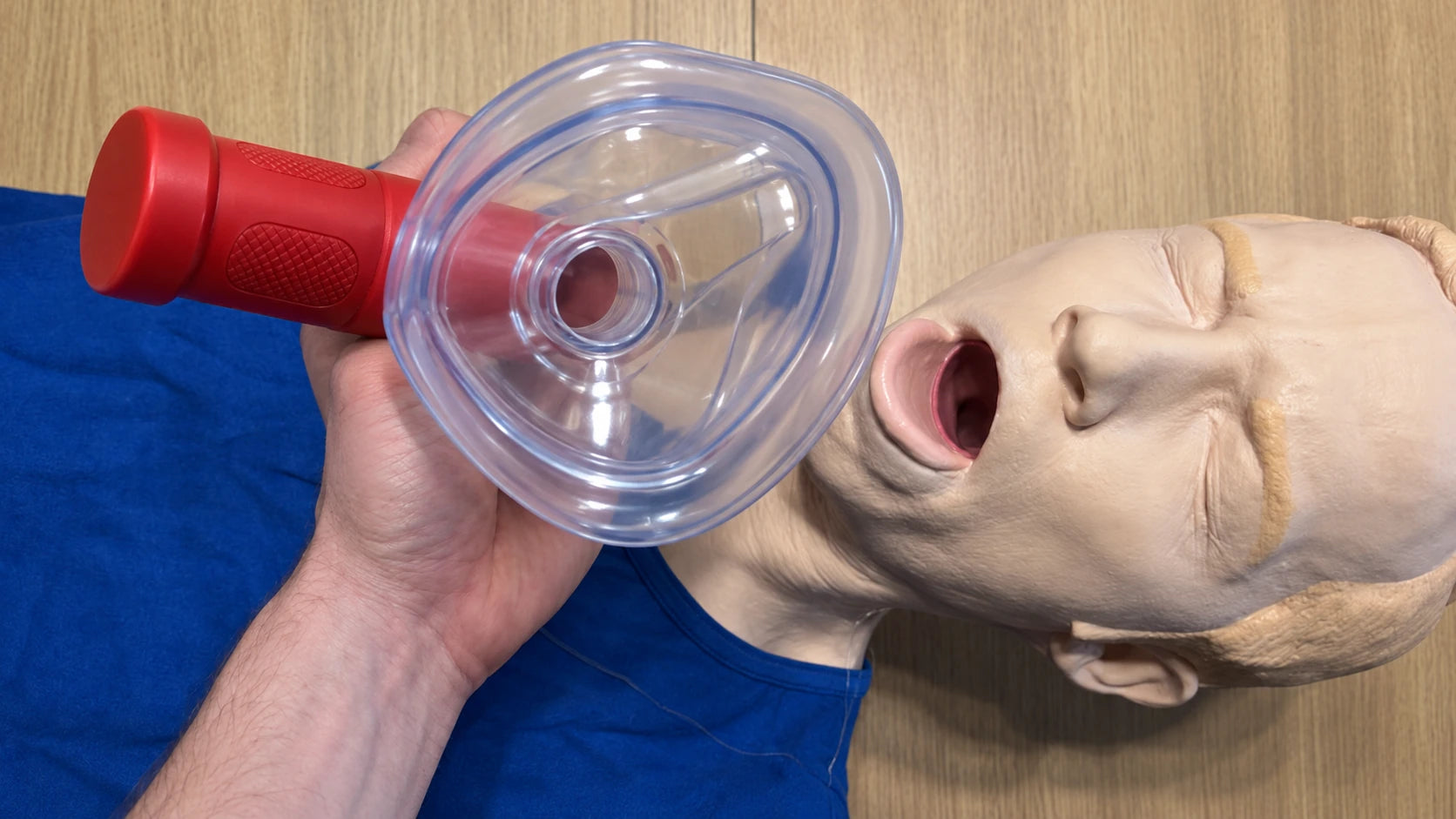 RescUAid mask sealed over a training manikin's mouth and nose