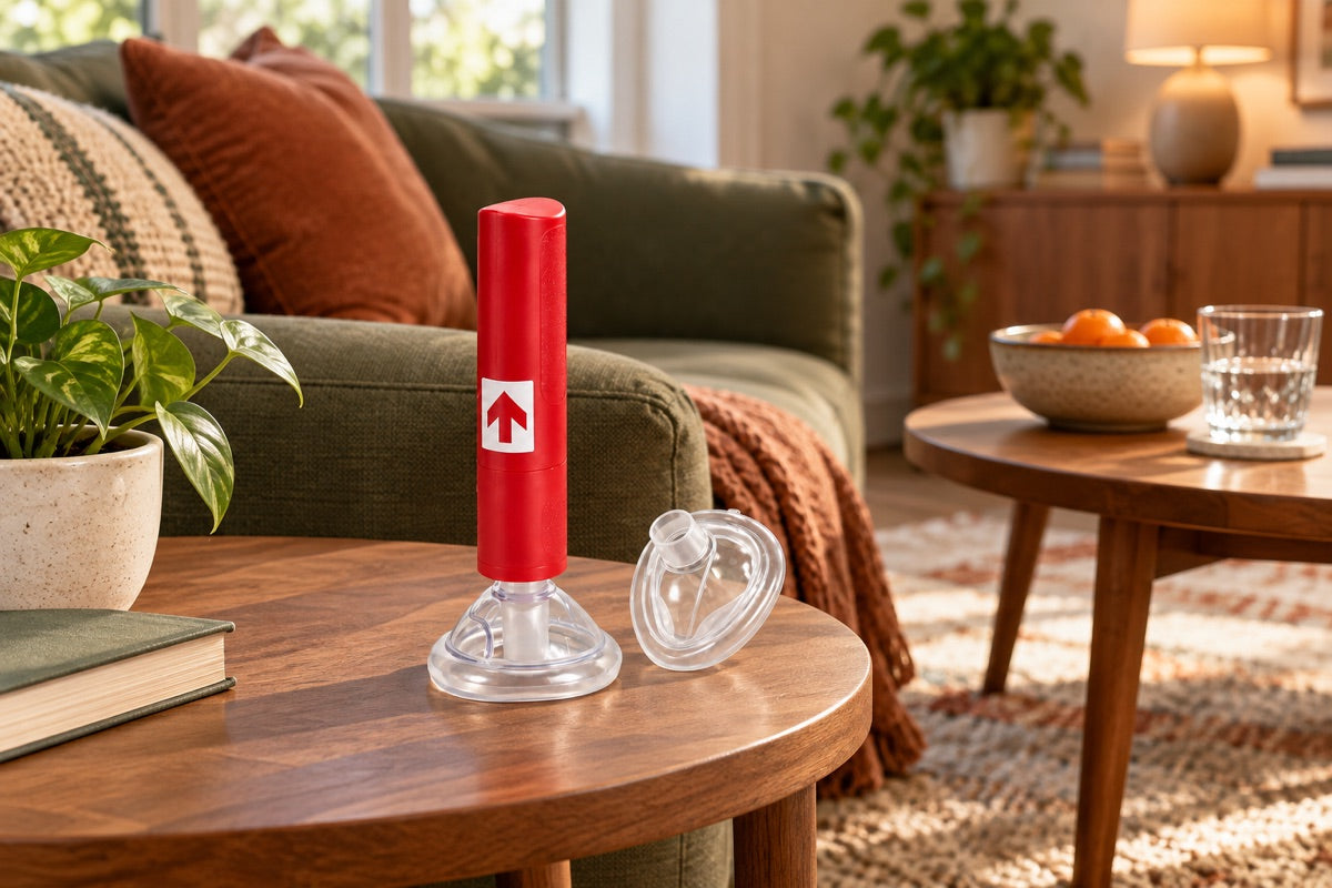A RescUAid device and spare mask on a side table beside a sofa; placement illustration.